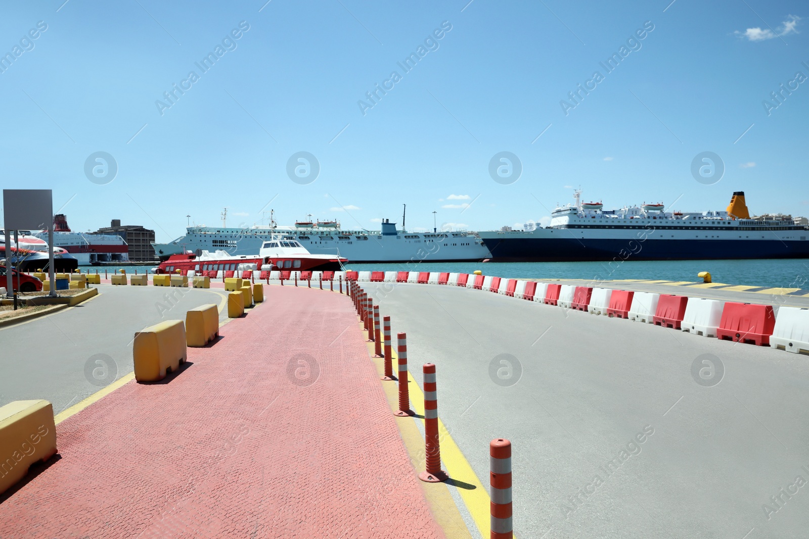 Photo of Picturesque view of port with road and modern boats on sunny day