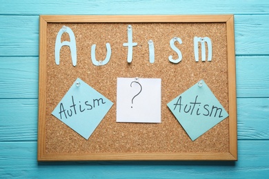 Photo of Sticky notes with word "Autism" on cork board