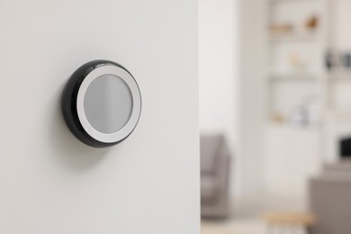 Photo of One thermostat on white wall indoors, space for text. Smart home system