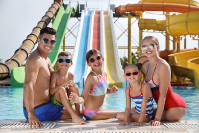 Photo of Happy family at poolside in water park