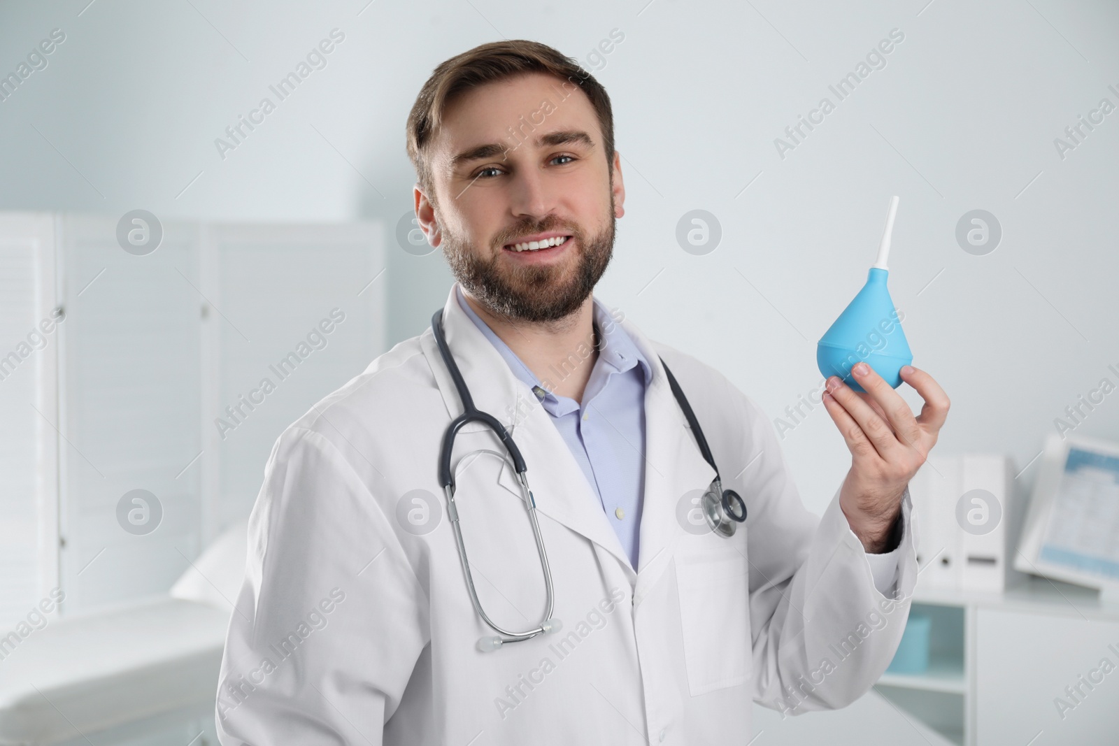 Photo of Doctor holding rubber enema in examination room