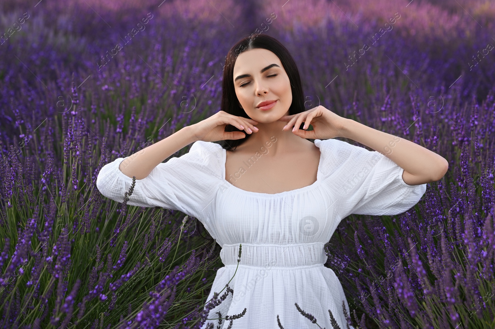 Photo of Portrait of beautiful young woman in lavender field