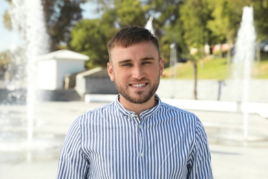 Portrait of handsome young man on street