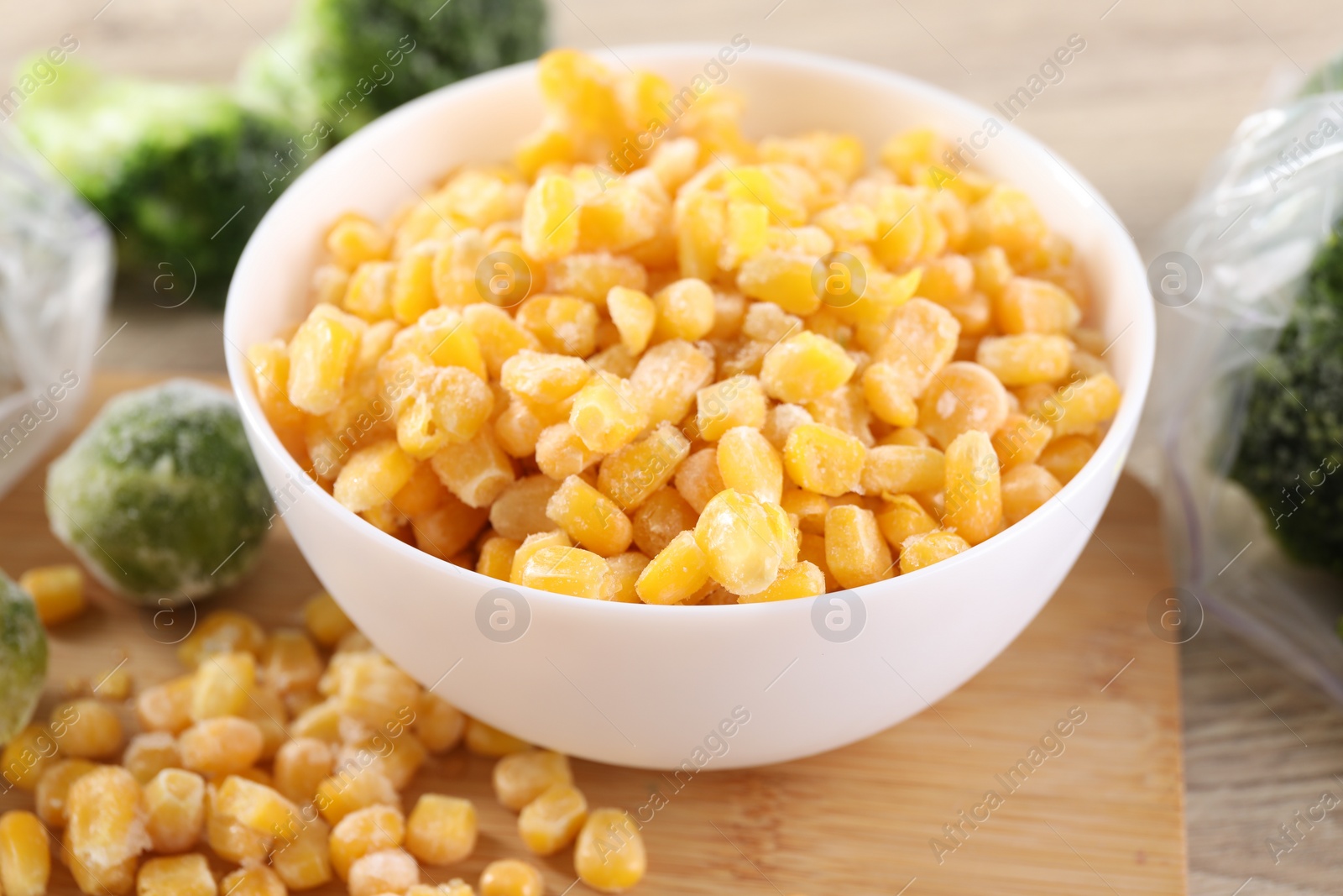 Photo of Frozen vegetables on wooden table, closeup view