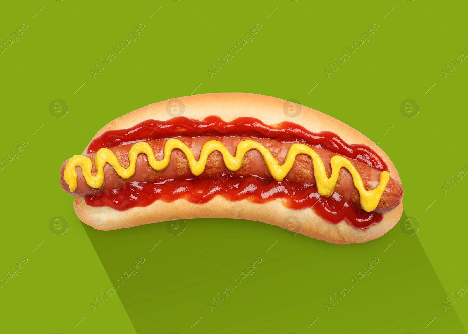 Image of Yummy hot dog with ketchup and mustard on green background