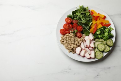 Photo of Vegetarian diet. Plate with tasty vegetables and quinoa on white marble table, top view. Space for text