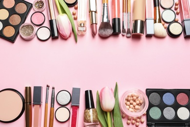 Photo of Flat lay composition with makeup products and flowers on color background, space for text