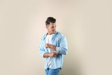 Photo of Young man in stylish jeans on color background