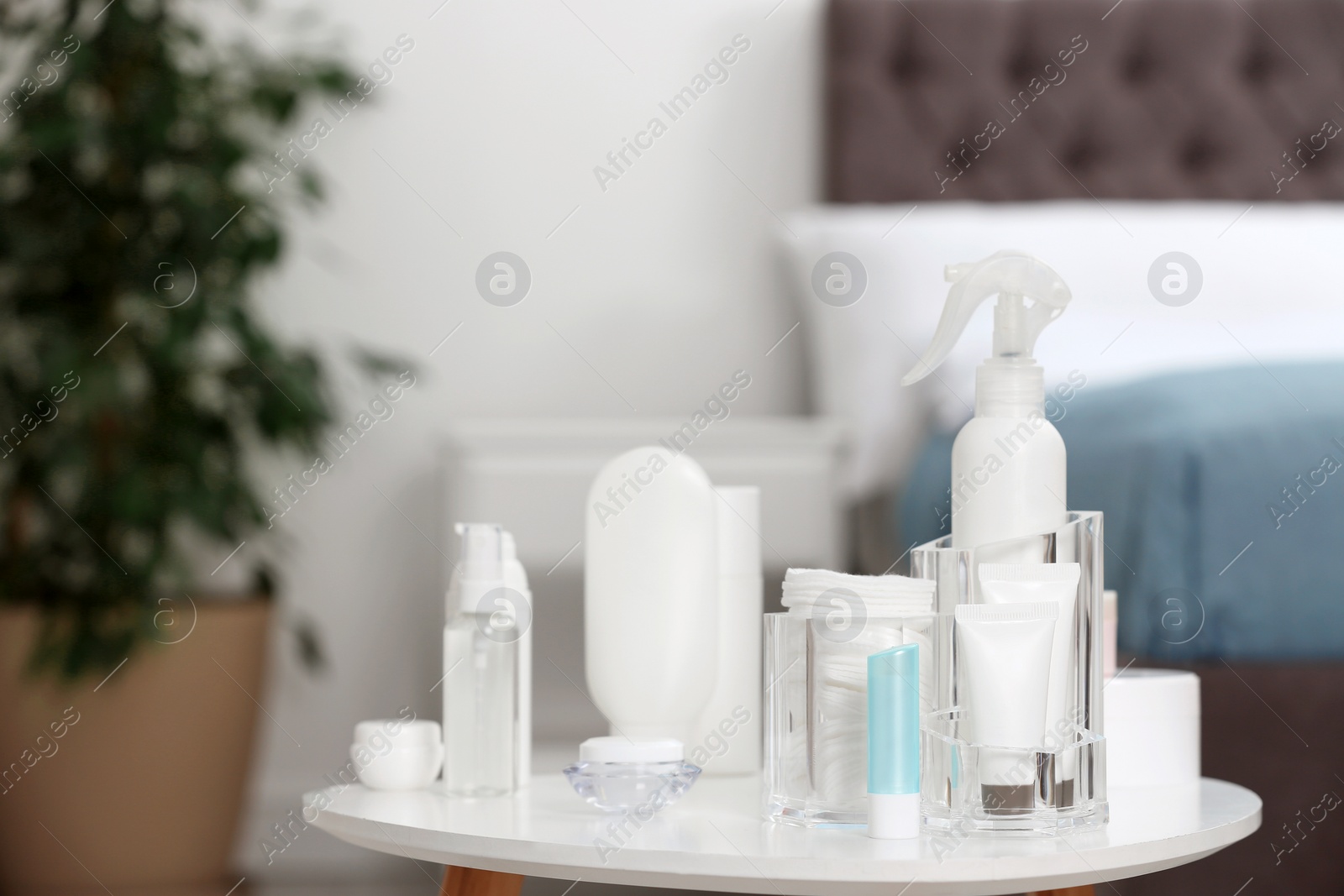 Photo of Set of cosmetic products on table against blurred background. Space for text