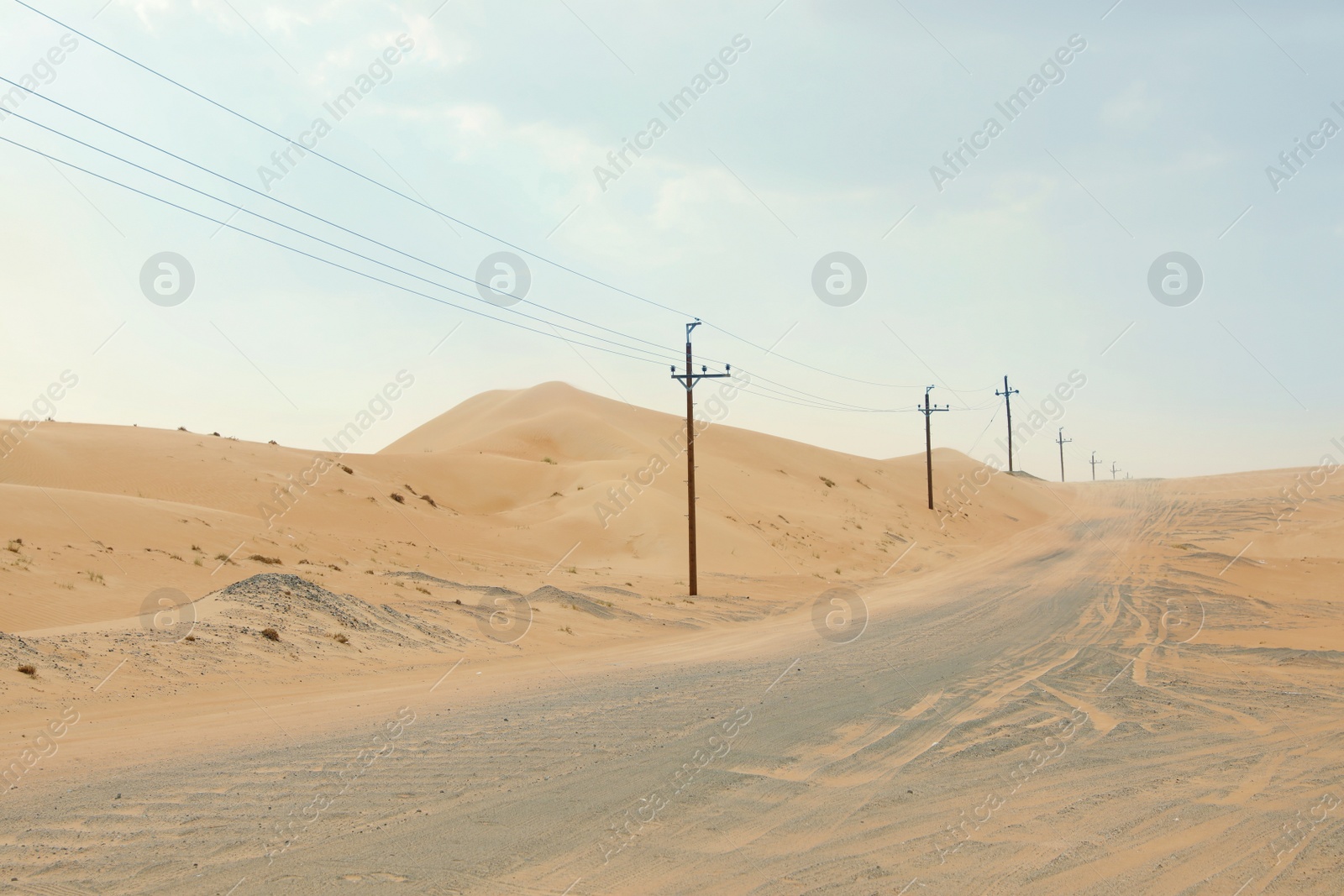 Photo of Electricity transmission line near road in desert