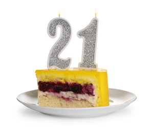 Photo of Coming of age party - 21st birthday. Delicious cake with number shaped candles on table against white background