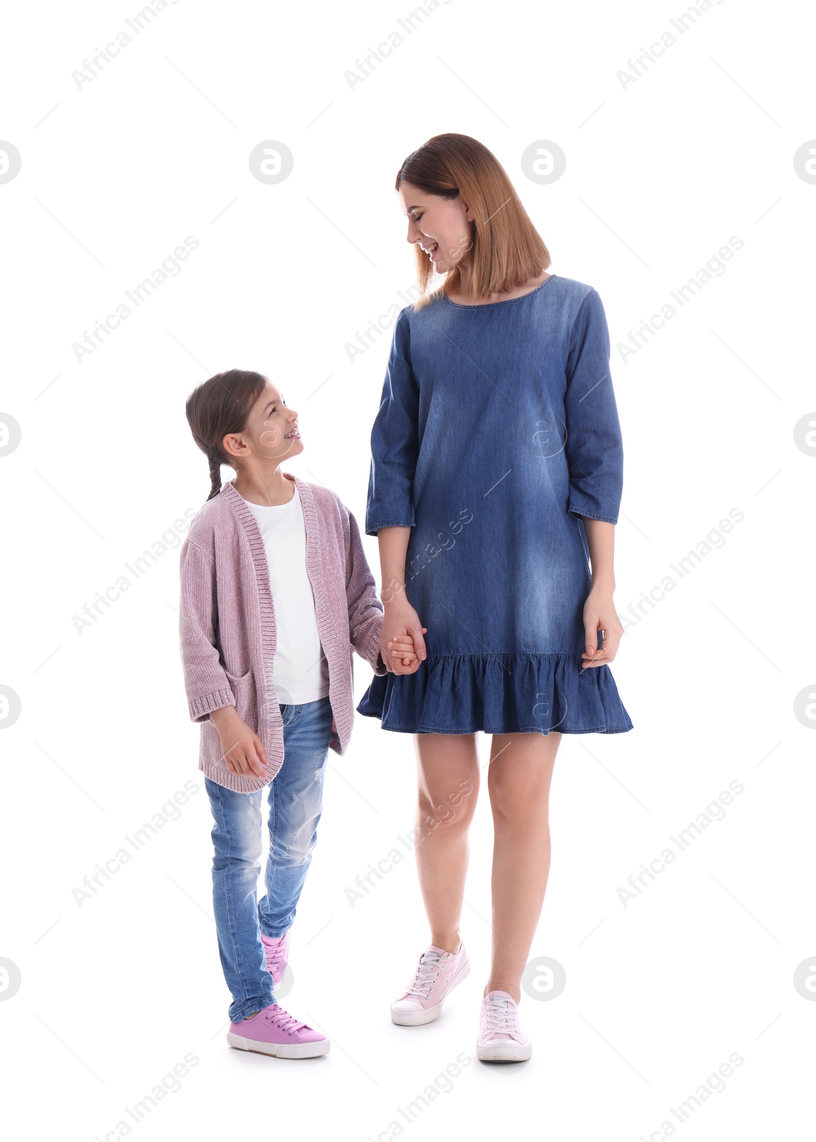 Photo of Happy woman and daughter in stylish clothes on white background