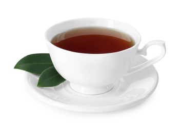 Photo of Aromatic tea in cup and green leaves isolated on white