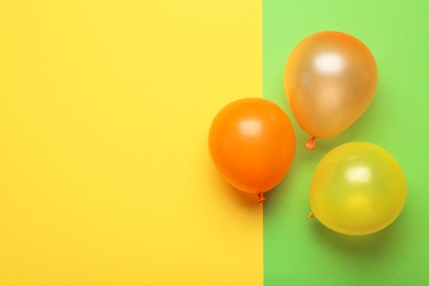 Photo of Flat lay composition with colorful balloons and space for text on color background