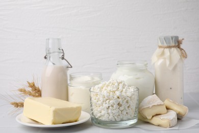 Different dairy products and spikes on white table