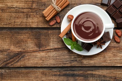 Photo of Flat lay composition with yummy hot chocolate on wooden table, space for text