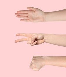 Image of People playing rock, paper and scissors on pink background, closeup