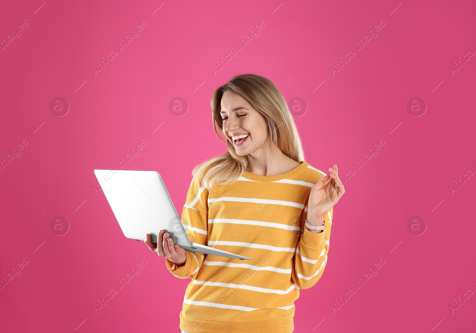 Photo of Portrait of young woman in casual outfit with laptop on color background