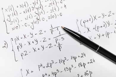 Photo of Sheet of paper with mathematical formulas and pen, top view