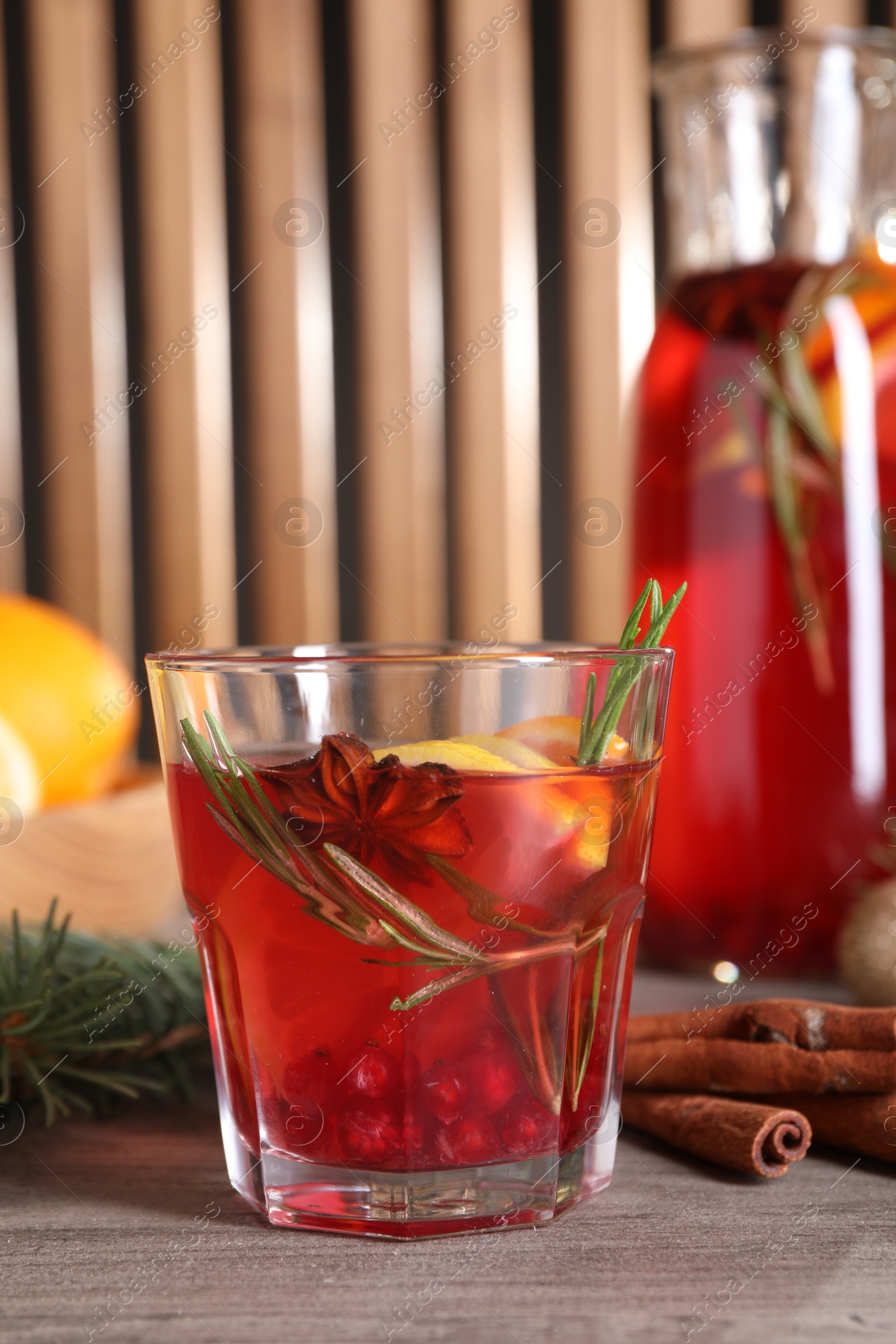 Photo of Aromatic punch drink on wooden table, space for text