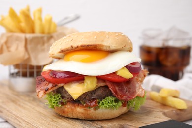 Photo of Delicious burger with fried egg on table, closeup