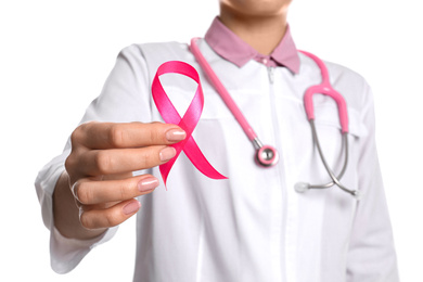 Photo of Doctor with pink ribbon and stethoscope on white background, closeup. Breast cancer awareness