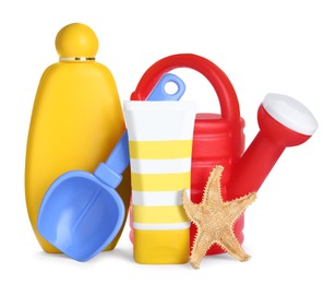 Different suntan products, starfish and plastic beach toys on white background