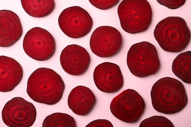 Slices of fresh beets on light background, flat lay