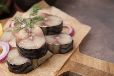 Photo of Slices of tasty salted mackerel and onion on brown table, closeup. Space for text