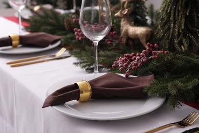 Beautiful festive place setting with Christmas decor on table