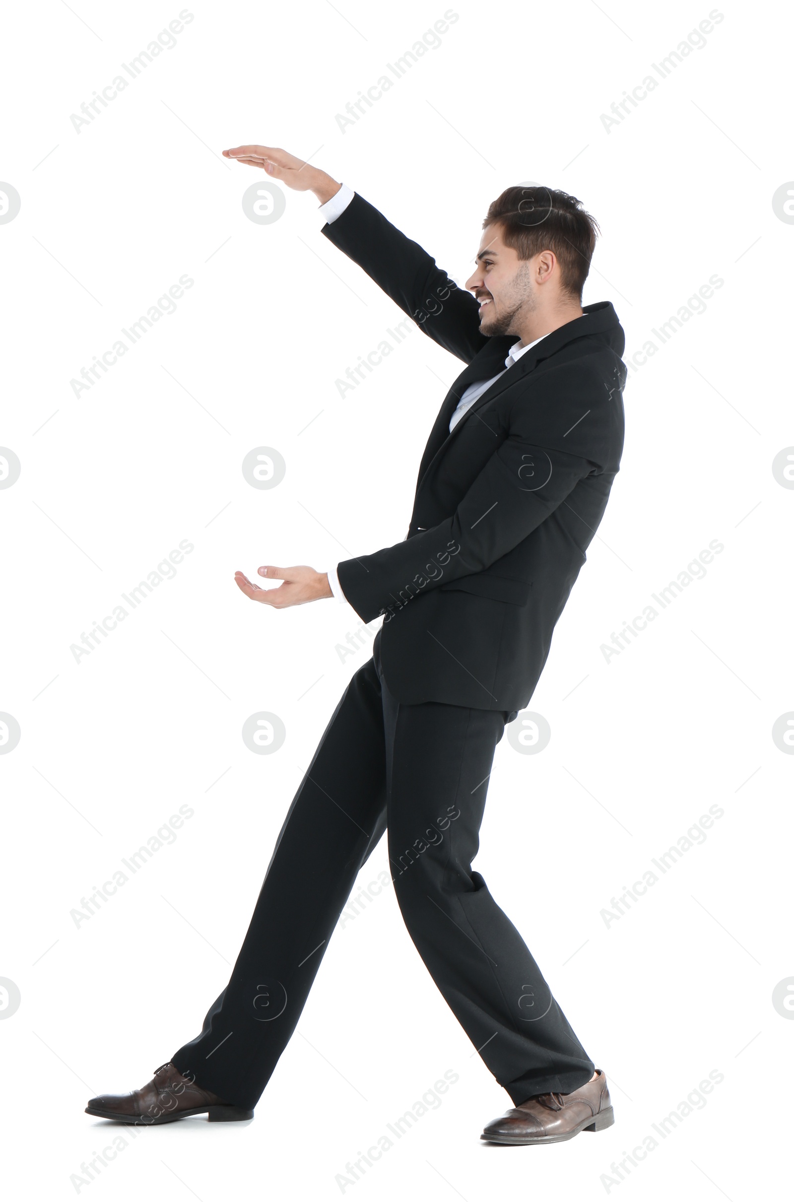 Photo of Young businessman with magnet attracting people on white background