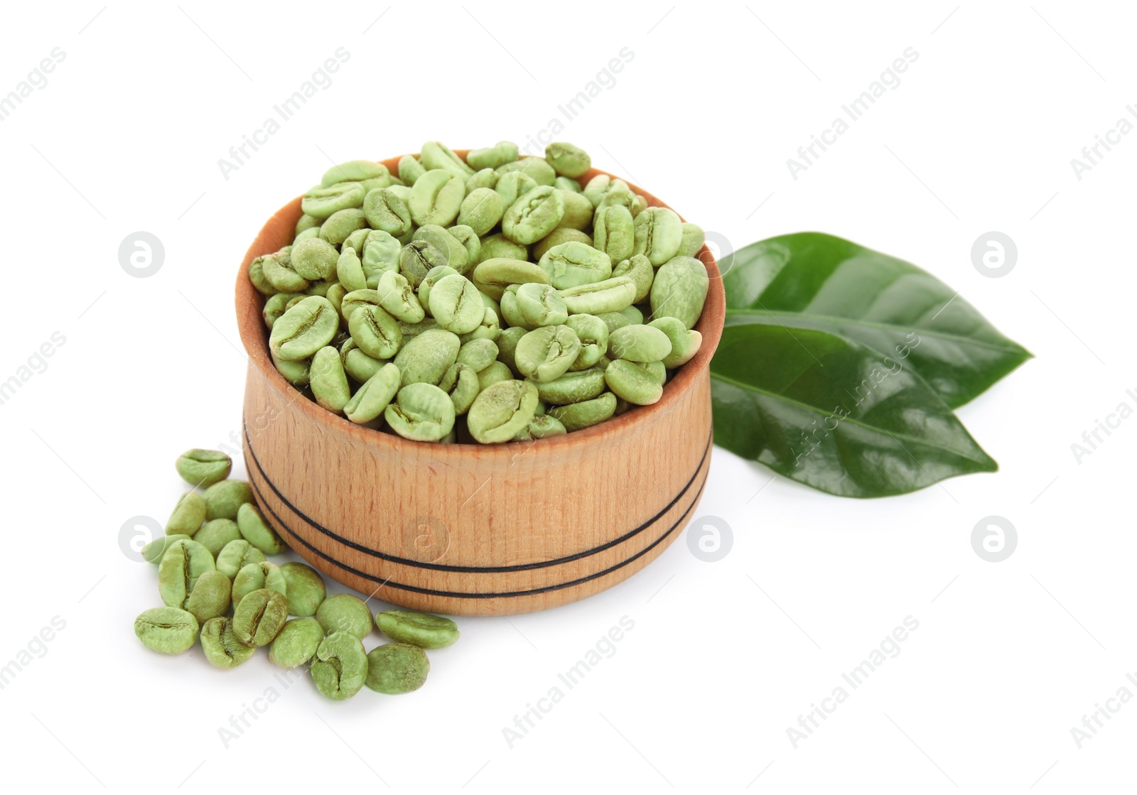 Photo of Wooden bowl with green coffee beans and fresh leaves on white background