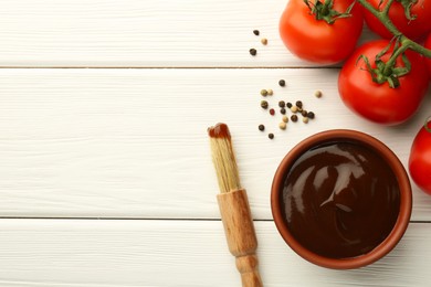 Photo of Flat lay composition with tasty barbeque sauce in bowl on white wooden table. Space for text