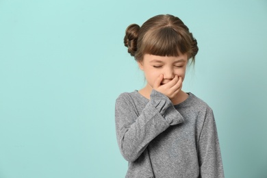 Photo of Little girl coughing on color background