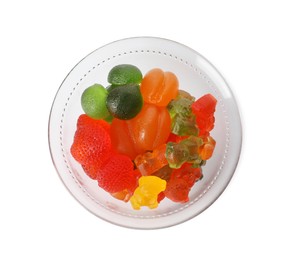 Photo of Different delicious gummy candies in glass bowl on white background, top view
