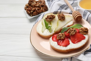 Plate with different tasty ricotta bruschettas on white wooden table, closeup. Space for text