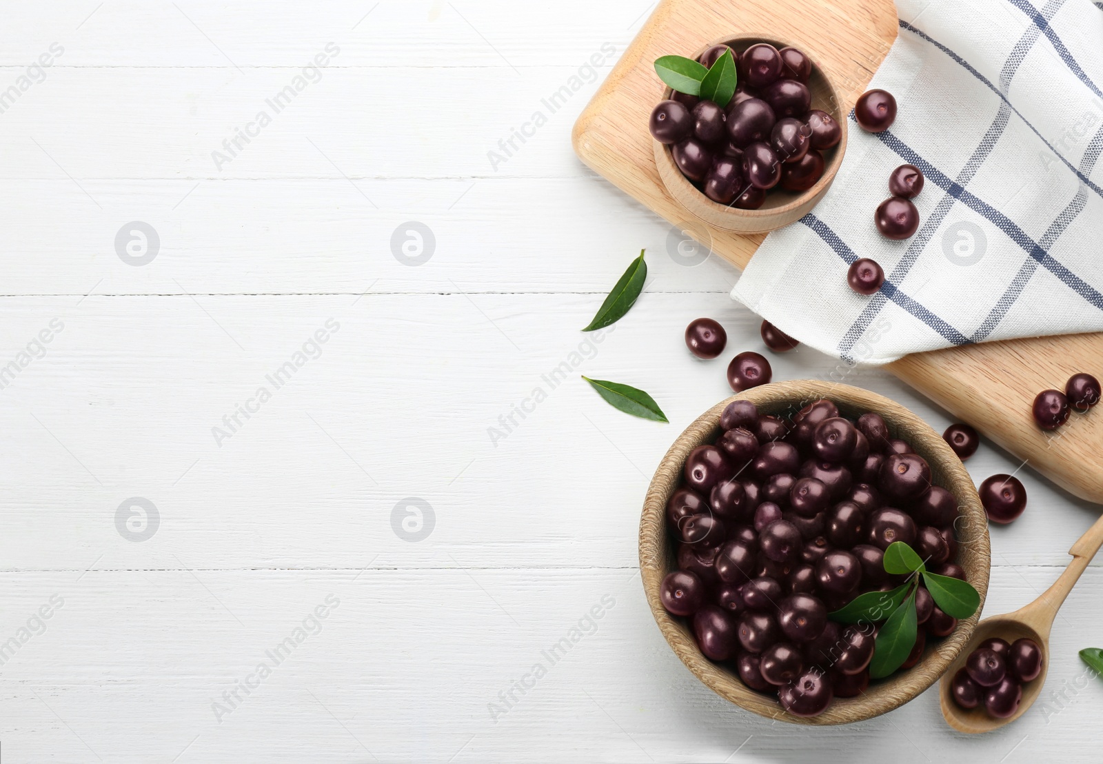 Photo of Flat lay composition with tasty acai berries on white wooden table. Space for text