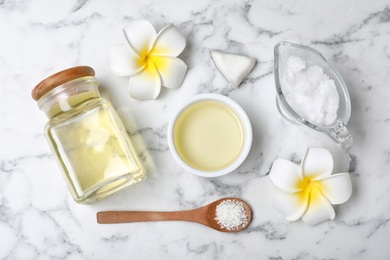 Flat lay composition with natural organic coconut oil on marble background