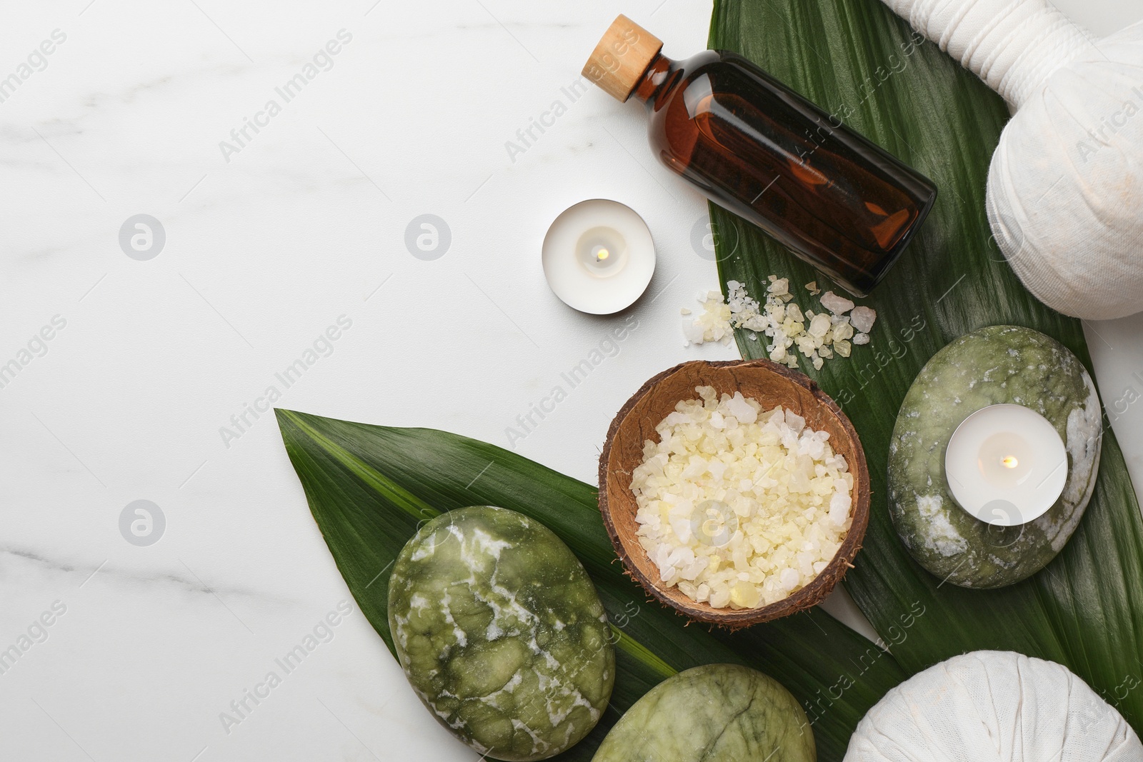 Photo of Flat lay composition with spa products .and candles on white marble table. Space for text