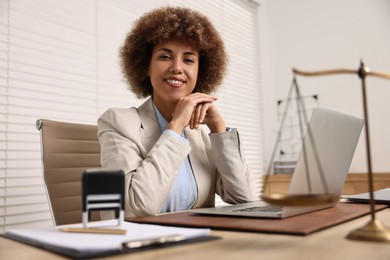 Notary with laptop at workplace in office