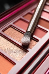 Photo of Beautiful eye shadow palette and brush, closeup view