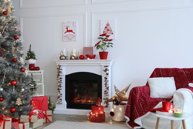 Living room with fireplace and Christmas decorations. Festive interior design