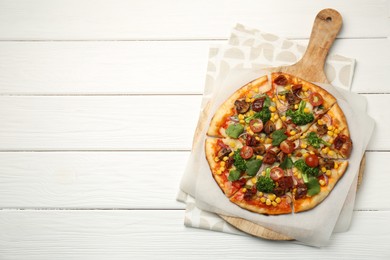 Photo of Delicious vegetarian pizza with mushrooms, vegetables and parsley on white wooden table, top view. Space for text