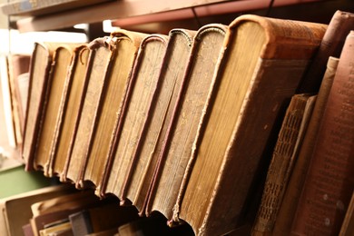 Photo of Collection of old books in library, closeup