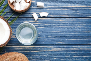 Photo of Flat lay composition with coconut oil on blue wooden table, space for text