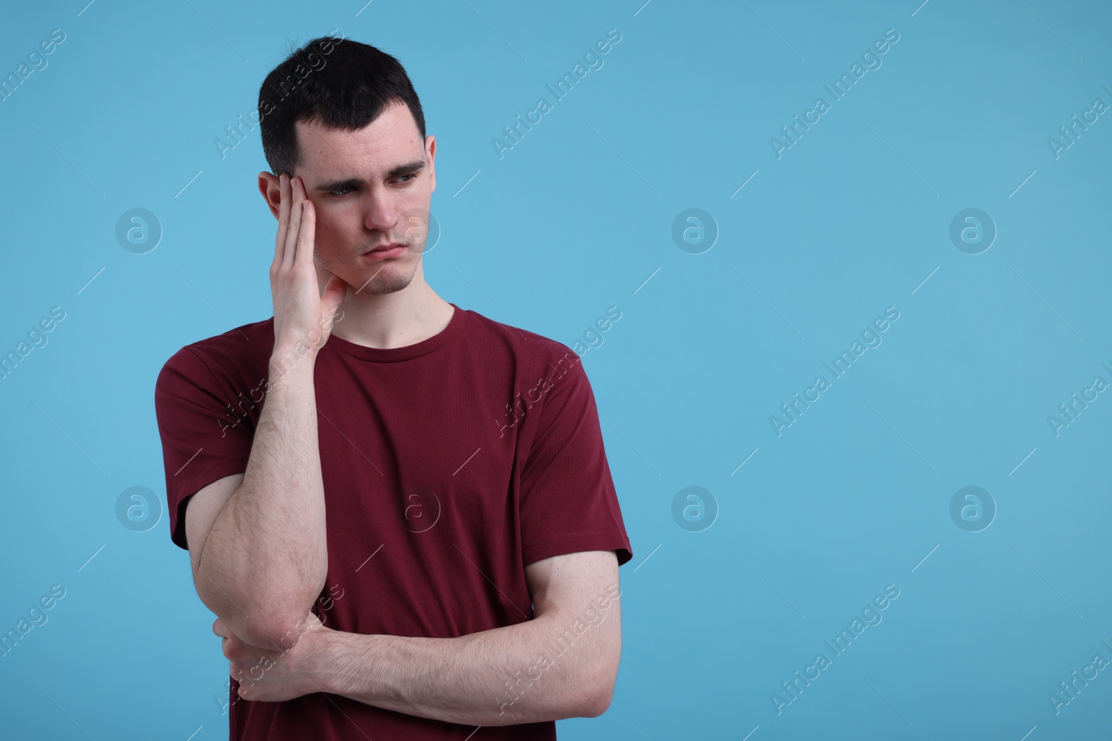 Photo of Portrait of sad man on light blue background, space for text