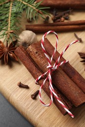 Different spices, nut and fir branches on table, above view