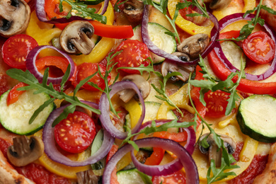 Delicious hot vegetable pizza with mushrooms as background, closeup