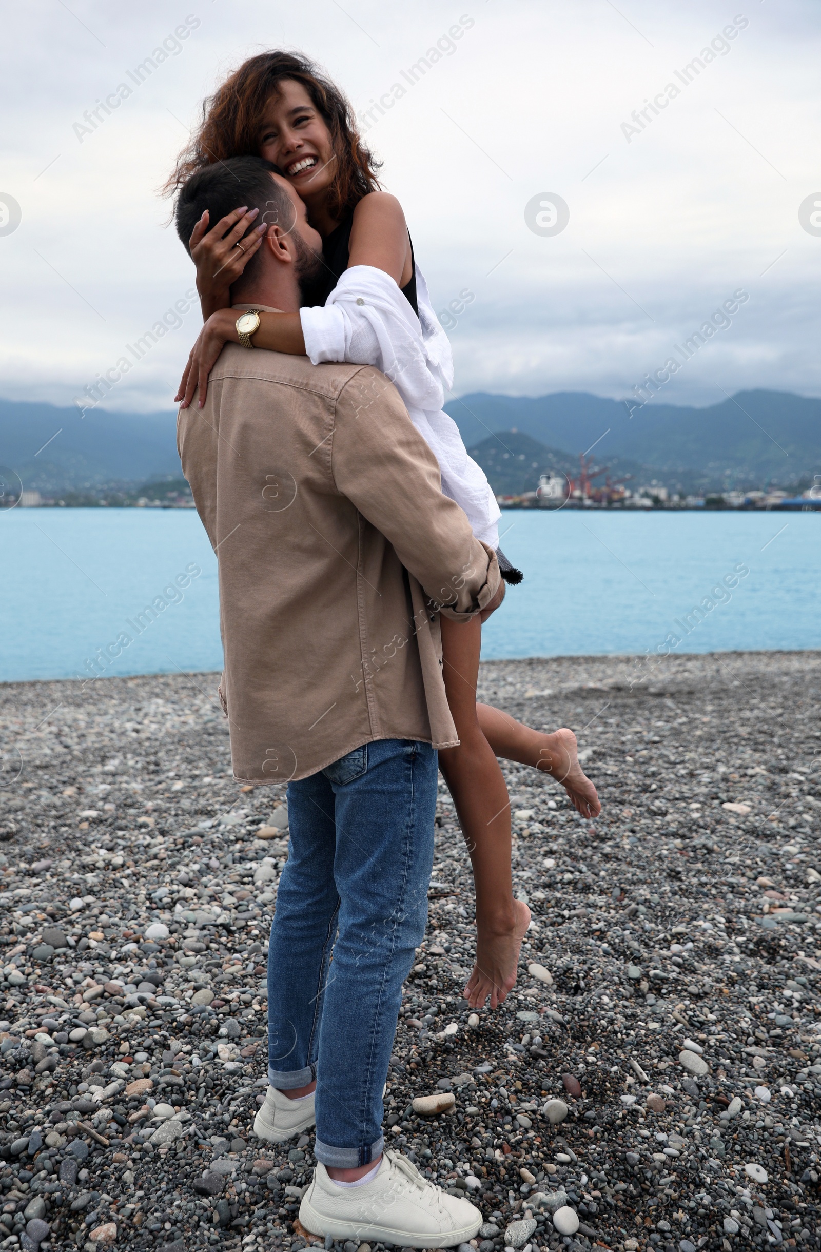 Photo of Beautiful young couple enjoying time together on beach