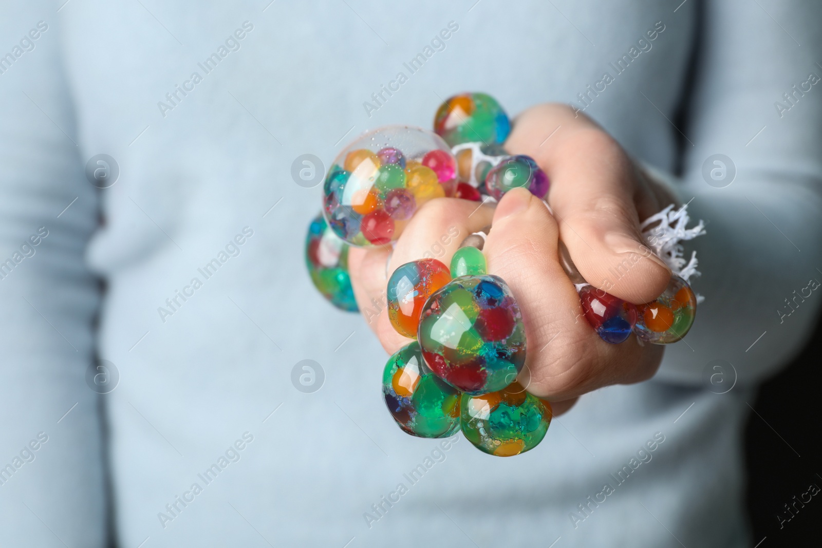 Photo of Woman squeezing colorful slime, closeup. Antistress toy